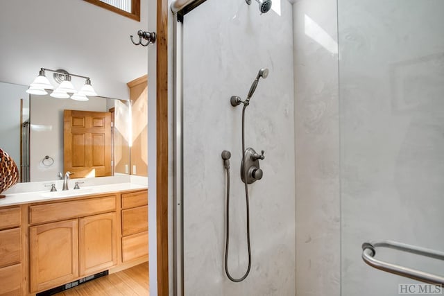 bathroom featuring vanity, a shower with door, and hardwood / wood-style floors