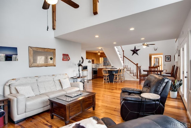 living room with light hardwood / wood-style floors and ceiling fan