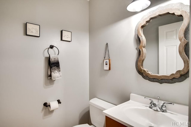 bathroom featuring toilet and vanity