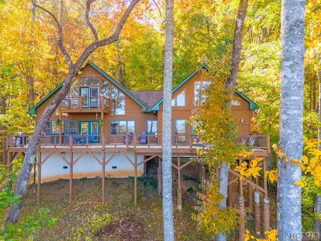 rear view of house featuring a wooden deck