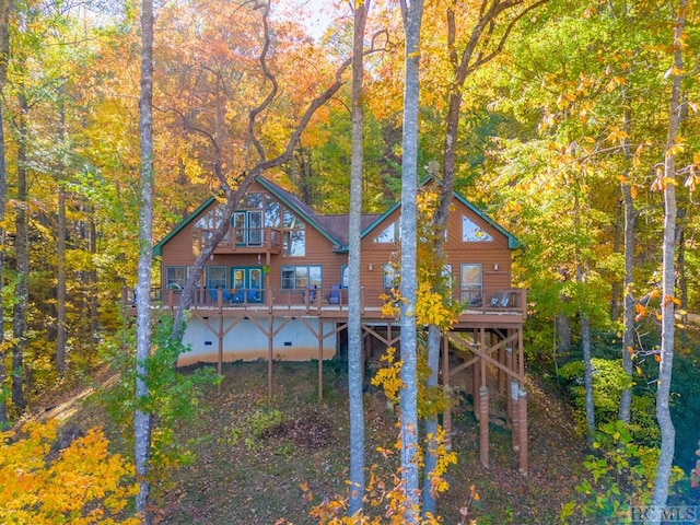 back of property featuring a wooden deck