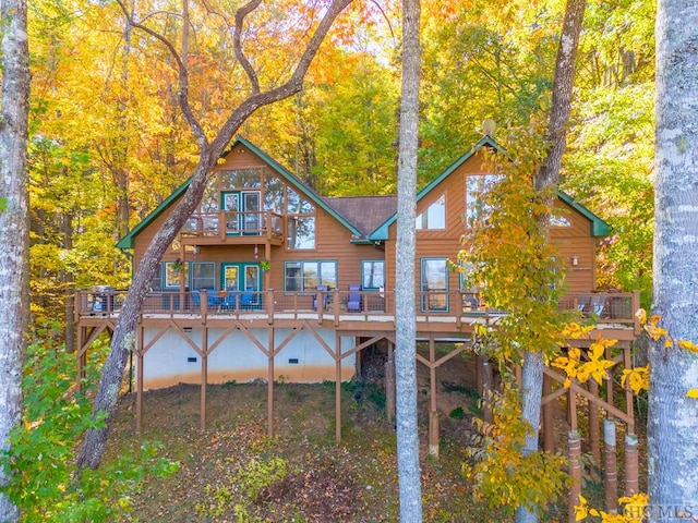 rear view of property featuring a wooden deck