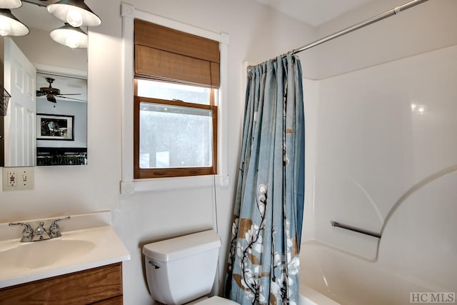 full bathroom featuring toilet, vanity, shower / bathtub combination with curtain, and ceiling fan