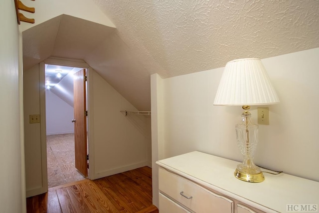 interior space with vaulted ceiling and wood-type flooring