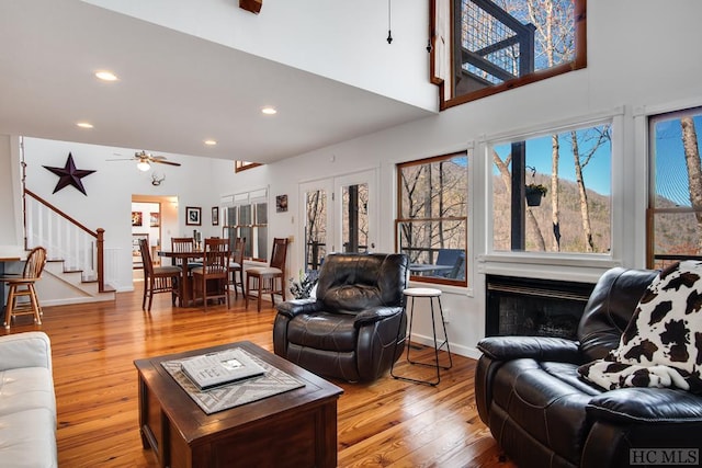 living room with ceiling fan and light wood-type flooring