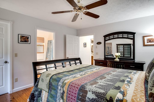 bedroom featuring a textured ceiling, ceiling fan, and light hardwood / wood-style flooring