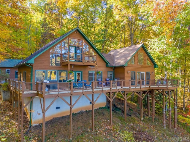 back of house with a deck and a balcony