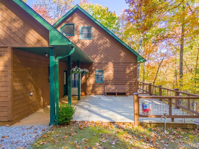 view of property exterior with a patio area