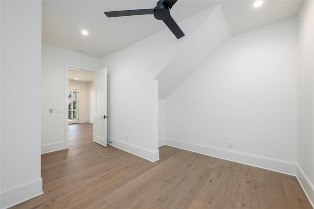 additional living space with light wood-style flooring, ceiling fan, and baseboards