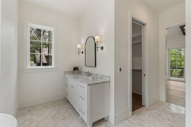 2608 Magnolia Dr, Highlands, NC 28741 - bathroom featuring plenty of natural light, vanity, and a walk in closet