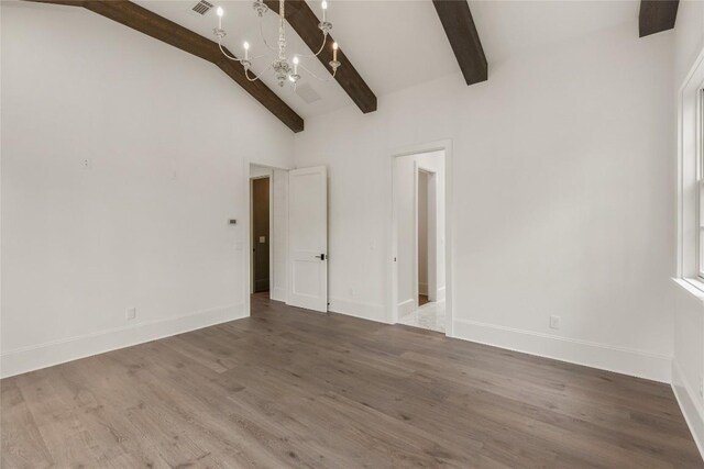 2608 Magnolia Dr, Highlands, NC 28741 - unfurnished room with a chandelier, beam ceiling, wood finished floors, and high vaulted ceiling