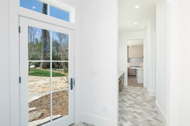 entryway featuring baseboards, plenty of natural light, and recessed lighting