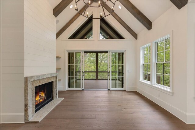 2608 Magnolia Dr, Highlands, NC 28741 - unfurnished living room with beam ceiling, plenty of natural light, high vaulted ceiling, a premium fireplace, and dark wood-style flooring