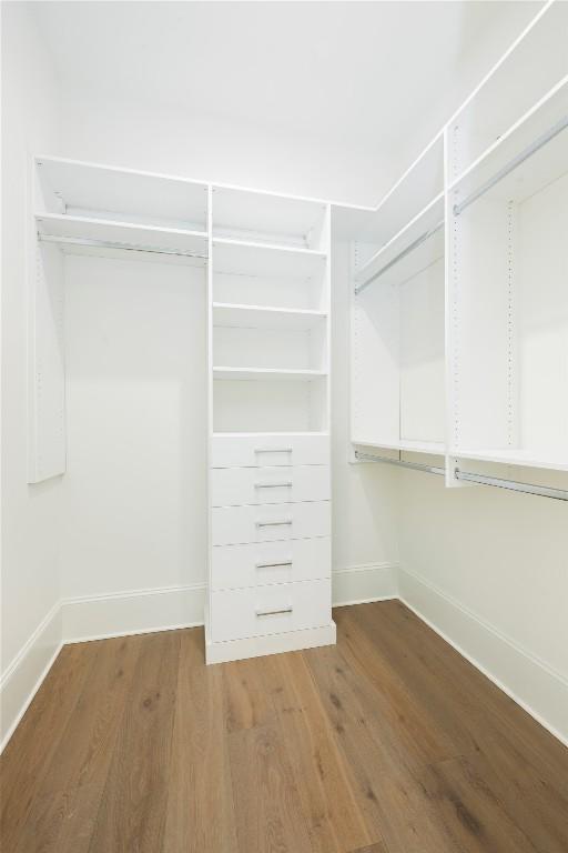 spacious closet featuring wood finished floors