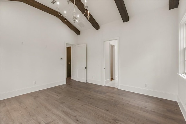 2608 Magnolia Dr, Highlands, NC 28741 - unfurnished room featuring a chandelier, beamed ceiling, wood finished floors, and high vaulted ceiling