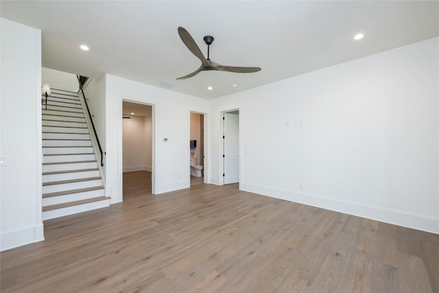 unfurnished living room featuring recessed lighting, stairs, light wood-style floors, and ceiling fan