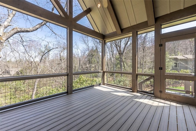 unfurnished living room with a chandelier, a warm lit fireplace, wood finished floors, and visible vents