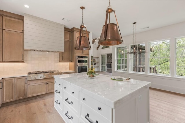2608 Magnolia Dr, Highlands, NC 28741 - kitchen with stainless steel appliances, light wood-type flooring, light stone counters, decorative backsplash, and recessed lighting