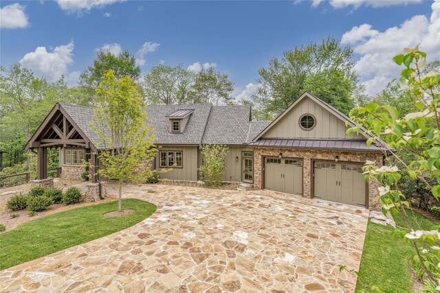 2608 Magnolia Dr, Highlands, NC 28741 - view of front facade featuring board and batten siding, a garage, and driveway
