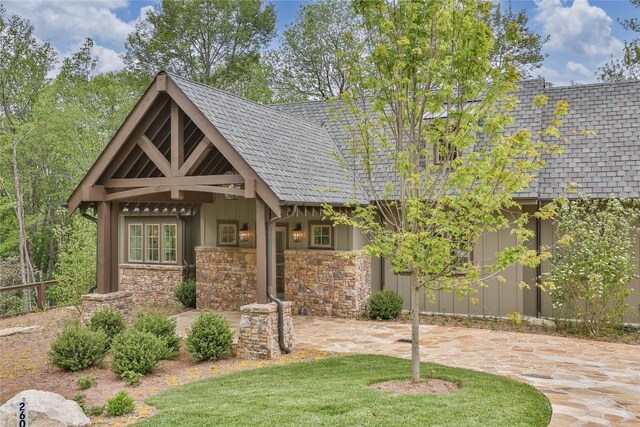 2608 Magnolia Dr, Highlands, NC 28741 - view of front of house with stone siding, board and batten siding, and a patio