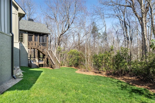 view of yard with a sunroom and stairway