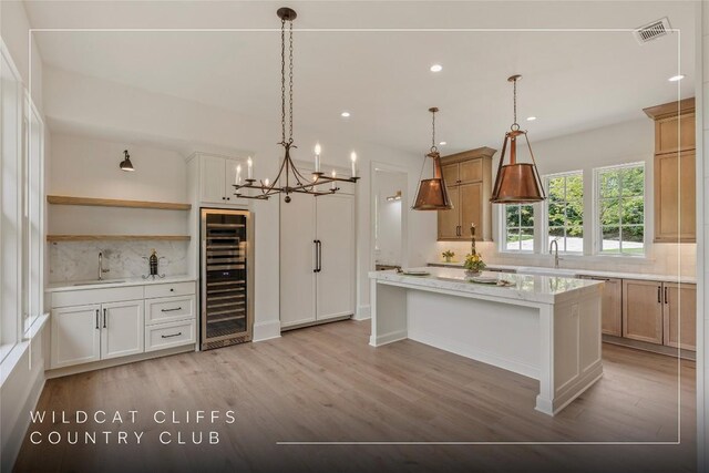 2608 Magnolia Dr, Highlands, NC 28741 - kitchen featuring beverage cooler, backsplash, light wood finished floors, a kitchen island, and recessed lighting