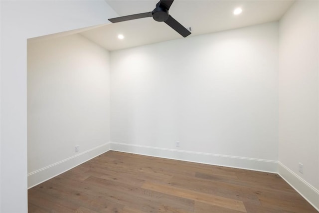 spare room with wood finished floors, baseboards, and a ceiling fan
