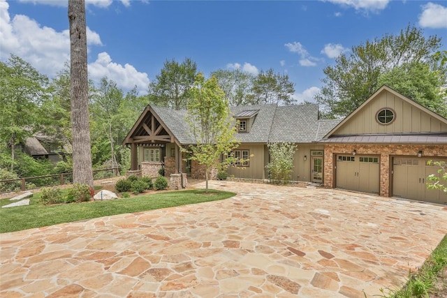 2608 Magnolia Dr, Highlands, NC 28741 - view of front of home featuring an attached garage, a standing seam roof, driveway, a metal roof, and board and batten siding