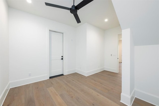 spare room with recessed lighting, baseboards, a ceiling fan, and wood finished floors