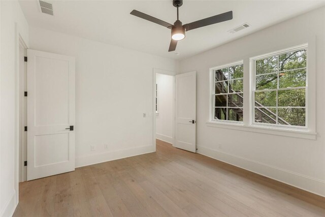2608 Magnolia Dr, Highlands, NC 28741 - unfurnished bedroom with light wood-style flooring and ceiling fan