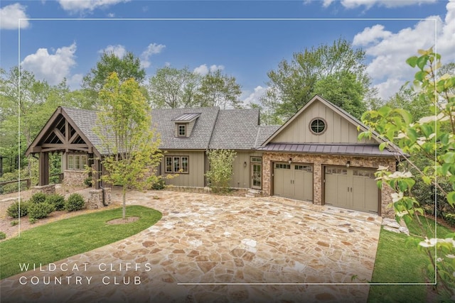 2608 Magnolia Dr, Highlands, NC 28741 - view of front of property featuring board and batten siding, an attached garage, driveway, and roof with shingles