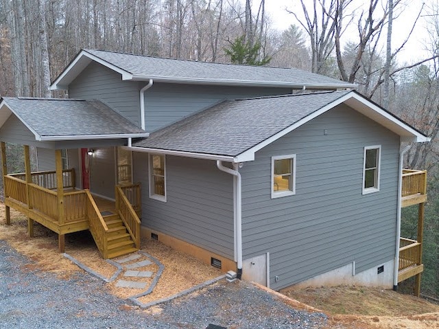 view of front of home featuring crawl space and a shingled roof