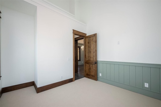 1086 Roaming Rd, Glenville, NC 28736 - carpeted spare room with wainscoting