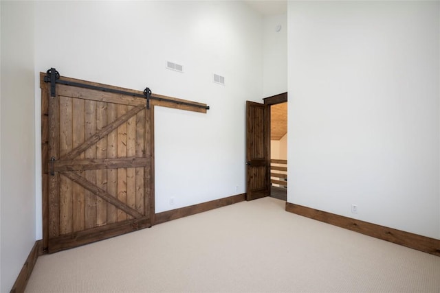 1086 Roaming Rd, Glenville, NC 28736 - carpeted spare room featuring baseboards, visible vents, and a high ceiling