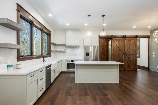 1086 Roaming Rd, Glenville, NC 28736 - kitchen featuring premium range hood, appliances with stainless steel finishes, dark wood-type flooring, open shelves, and a center island