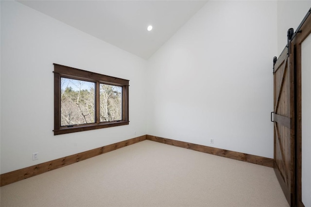 1086 Roaming Rd, Glenville, NC 28736 - carpeted spare room with baseboards, a barn door, high vaulted ceiling, and recessed lighting