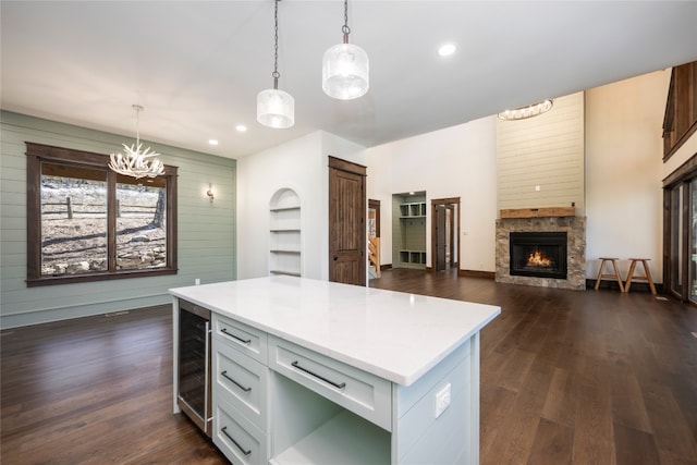 1086 Roaming Rd, Glenville, NC 28736 - kitchen with light countertops, a chandelier, dark wood finished floors, a stone fireplace, and beverage cooler