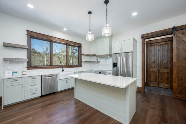 1086 Roaming Rd, Glenville, NC 28736 - kitchen with light countertops, open shelves, a barn door, stainless steel appliances, and dark wood-style flooring