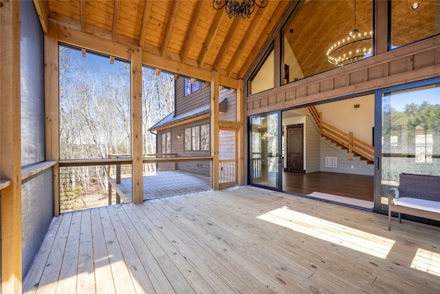 1086 Roaming Rd, Glenville, NC 28736 - unfurnished sunroom with beam ceiling, an inviting chandelier, and plenty of natural light