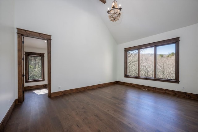 1086 Roaming Rd, Glenville, NC 28736 - unfurnished room with dark wood-style floors, high vaulted ceiling, baseboards, and an inviting chandelier
