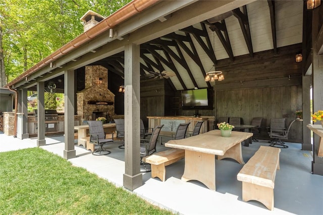 1086 Roaming Rd, Glenville, NC 28736 - view of patio with a ceiling fan, exterior kitchen, an outdoor stone fireplace, outdoor wet bar, and grilling area