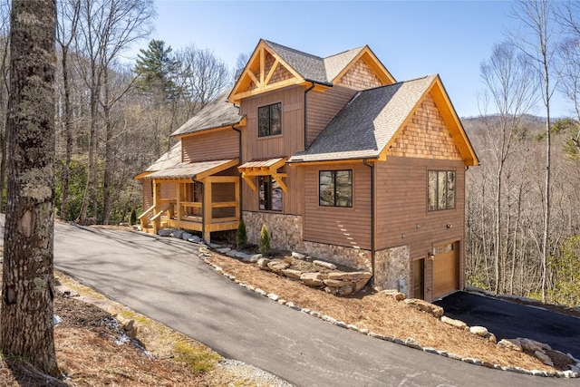 1086 Roaming Rd, Glenville, NC 28736 - view of front of property featuring stone siding, a garage, driveway, and a shingled roof