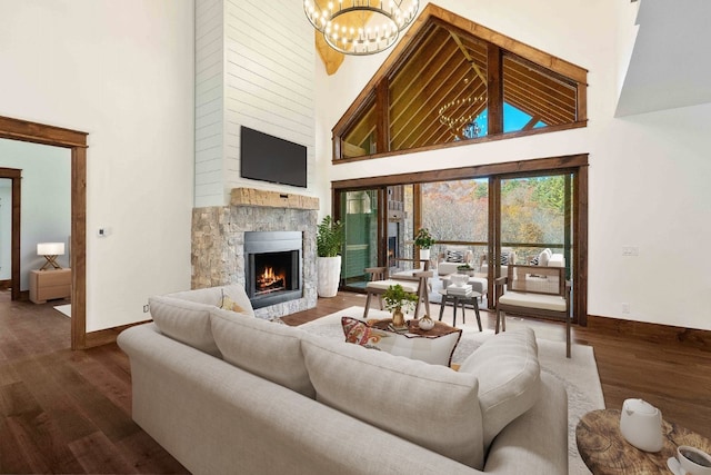 1086 Roaming Rd, Glenville, NC 28736 - living area featuring a fireplace, high vaulted ceiling, wood finished floors, and a chandelier