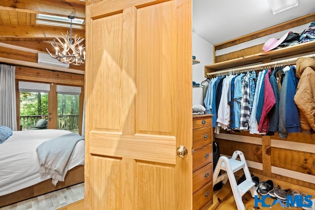 bedroom featuring access to exterior, a notable chandelier, and french doors