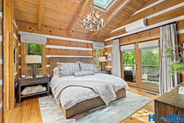 bedroom featuring access to exterior, vaulted ceiling with skylight, multiple windows, and a wall mounted AC