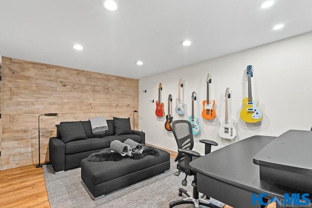 office space with wood walls, wood finished floors, and recessed lighting