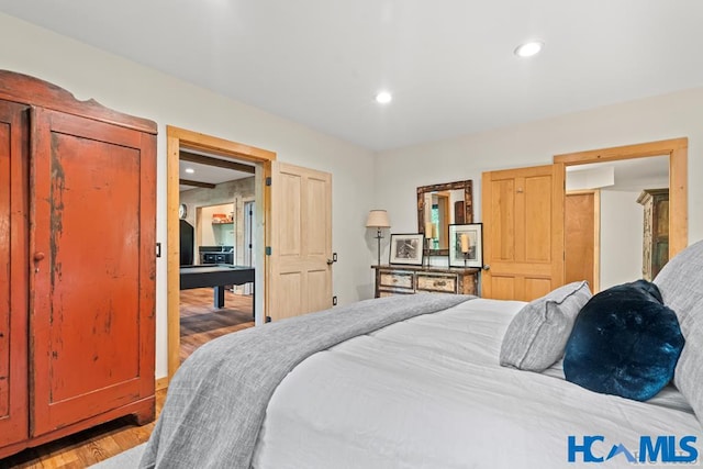 bedroom featuring light wood-type flooring and recessed lighting