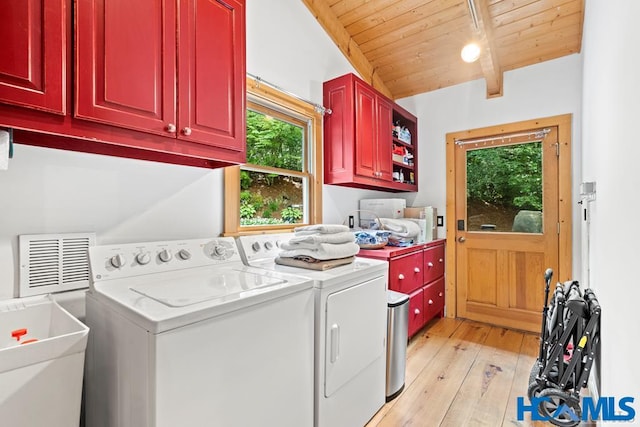 laundry area featuring cabinet space, wood ceiling, a sink, light wood-type flooring, and independent washer and dryer