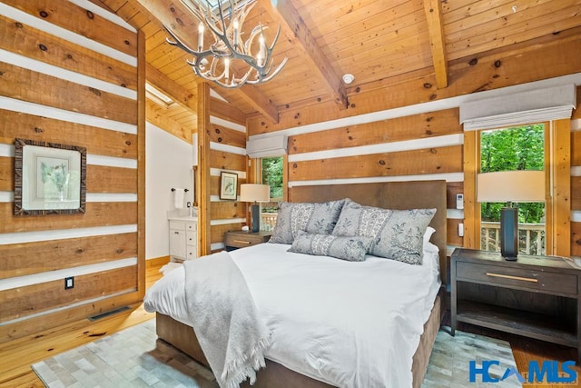 bedroom with a notable chandelier, lofted ceiling with beams, wooden walls, wood finished floors, and wooden ceiling