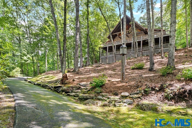 view of front of property with a view of trees